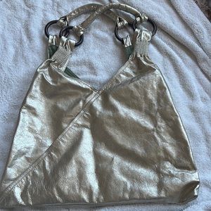 Silver purse tote bag with amazing straps and green interior on the inside